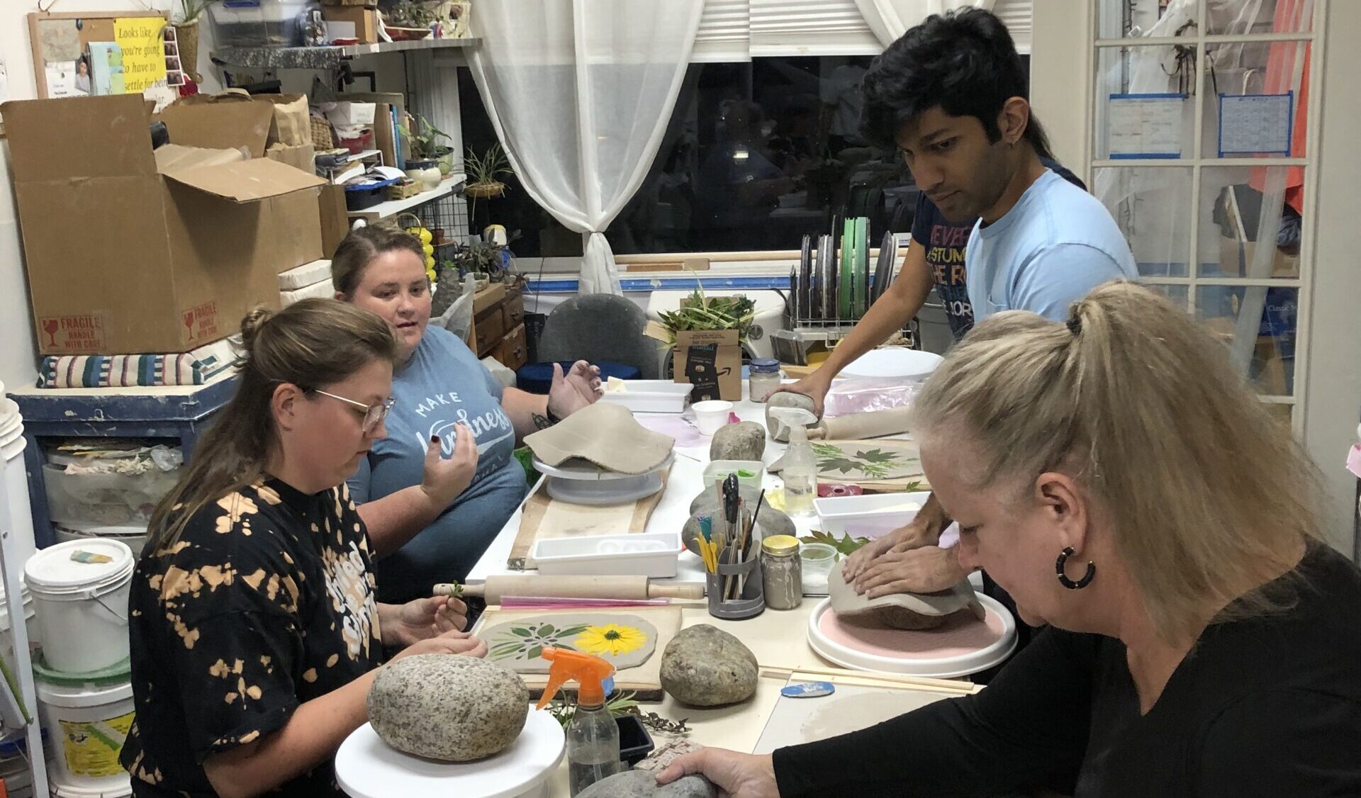 Students creating pottery.